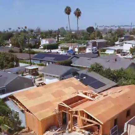 Aerial view of a new ADU under construction, wood framing and roof sheathing in a Los Angeles-area backyard