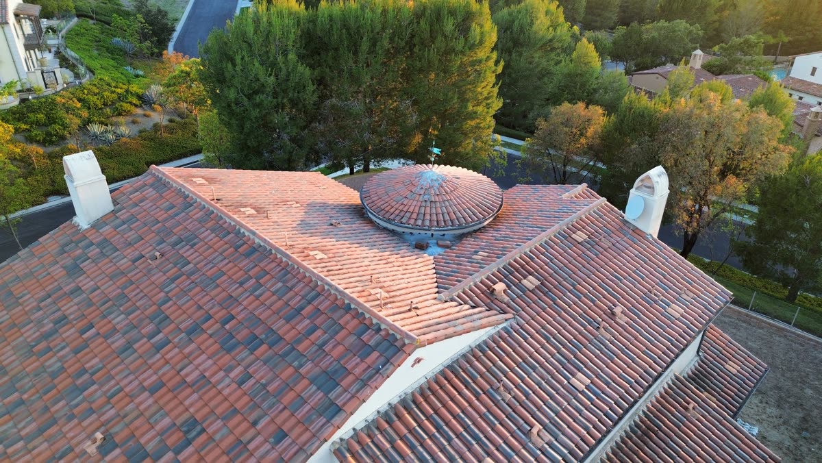 Clay tile roof with domed turret and chimneys from above