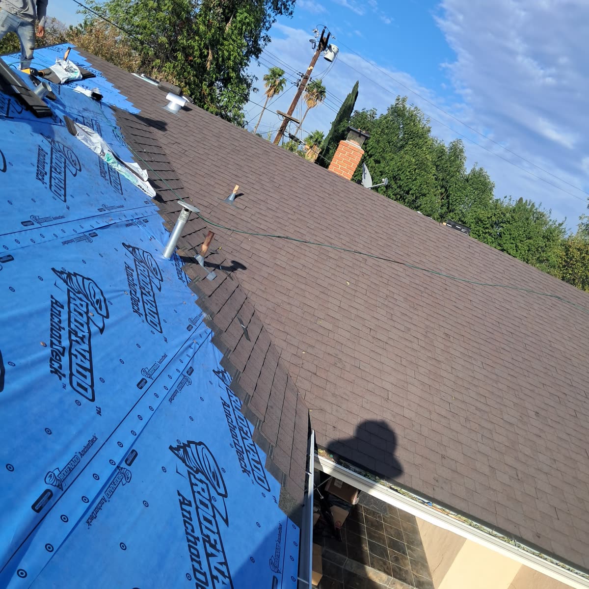 Underlayment and new shingles going on a residential roof
