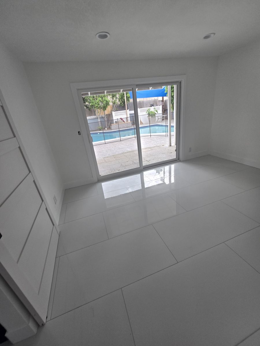 Bedroom with a sliding glass door looking out to the backyard pool