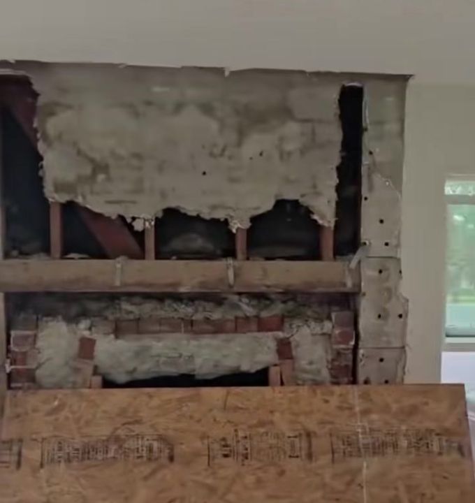 During the remodel: fireplace opened up before being converted to a decorative feature