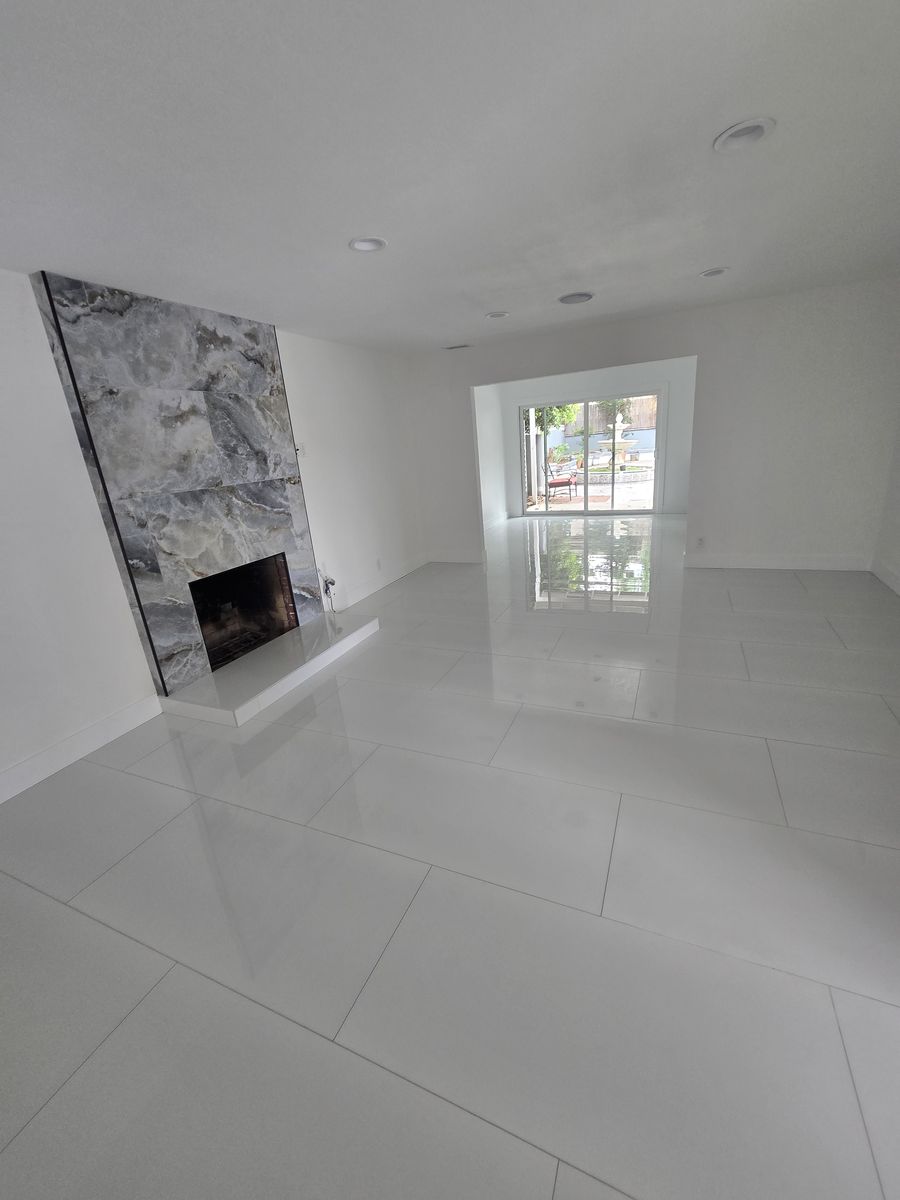 Decorative fireplace with a stone-look tile surround in the remodeled living room