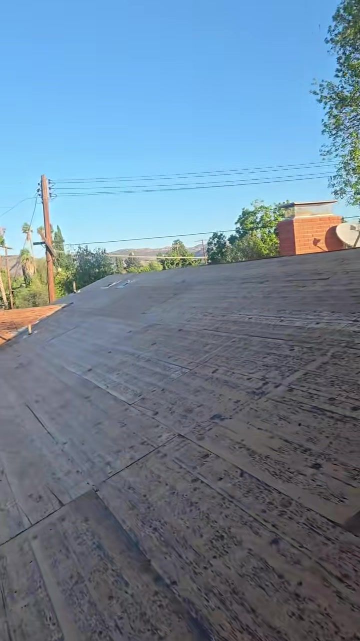 Bare plywood roof deck after tear-off, ready for the City sheathing inspection