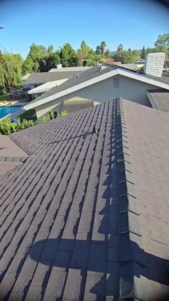 Walking the finished shingle roof on a sunny day in Woodland Hills